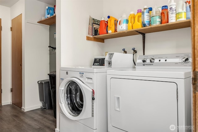 washroom featuring baseboards, dark wood-type flooring, and washer and clothes dryer