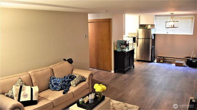 living room featuring a baseboard heating unit and wood finished floors