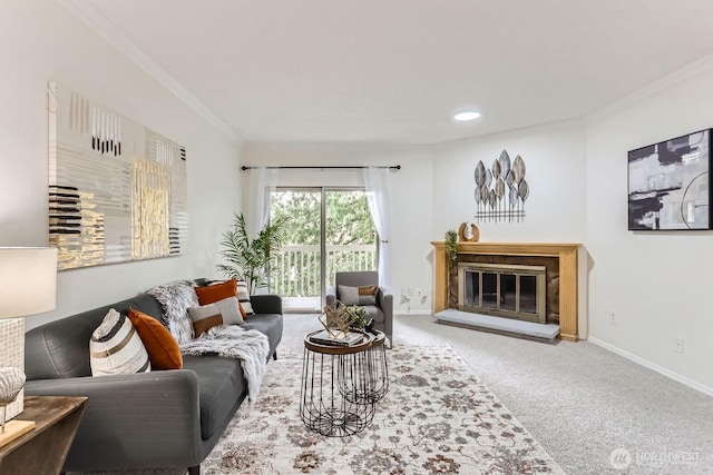 living room featuring a glass covered fireplace, carpet flooring, baseboards, and ornamental molding