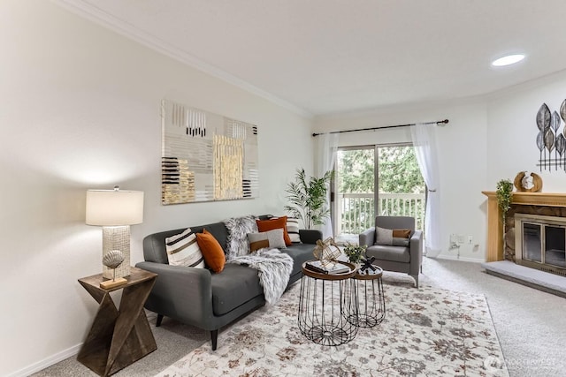 living area with baseboards, carpet, a glass covered fireplace, and crown molding