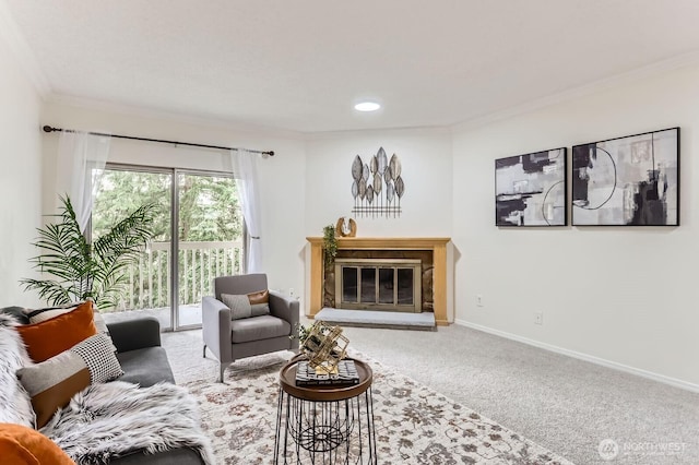 carpeted living room with a glass covered fireplace, baseboards, and ornamental molding