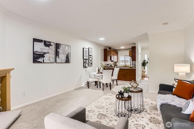 living area featuring crown molding, baseboards, and light carpet