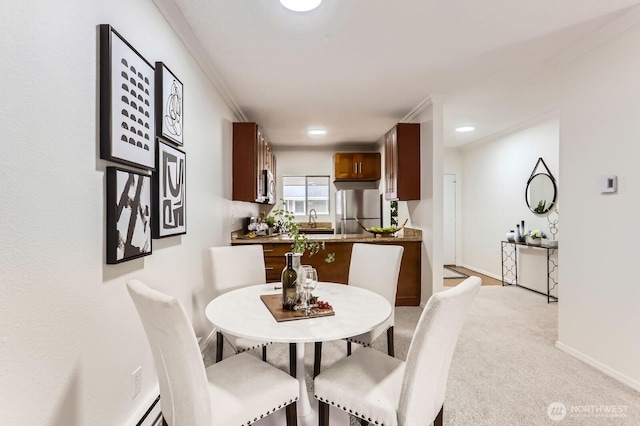 dining room with recessed lighting, baseboards, and light colored carpet