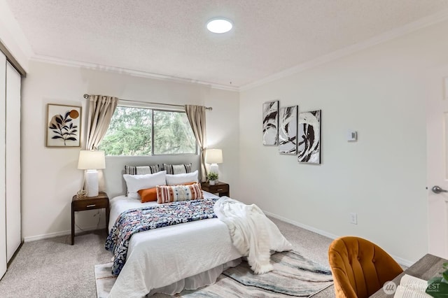 carpeted bedroom featuring crown molding, baseboards, and a textured ceiling