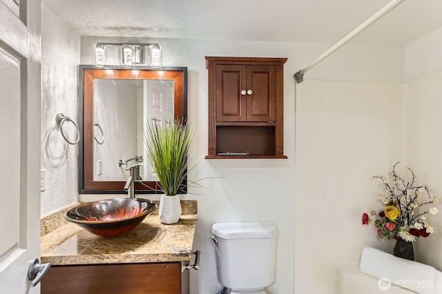 bathroom with toilet and vanity