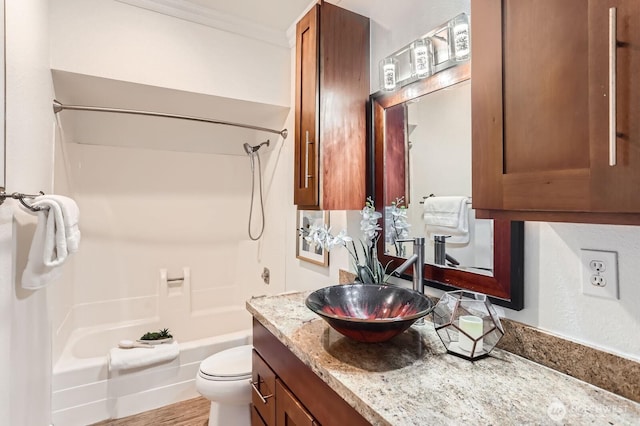 full bath with vanity, crown molding, toilet, and shower / washtub combination