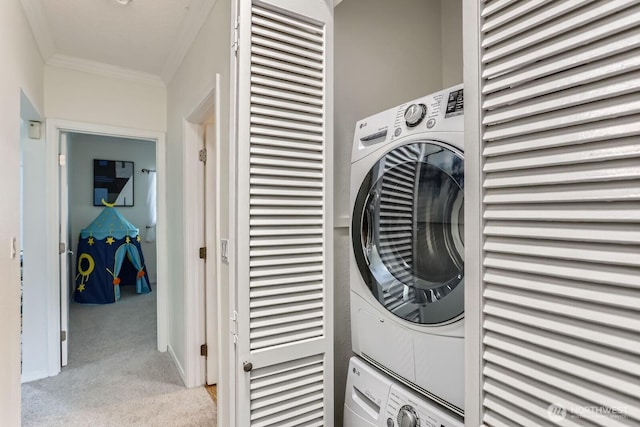 laundry room with light colored carpet, ornamental molding, laundry area, and stacked washing maching and dryer