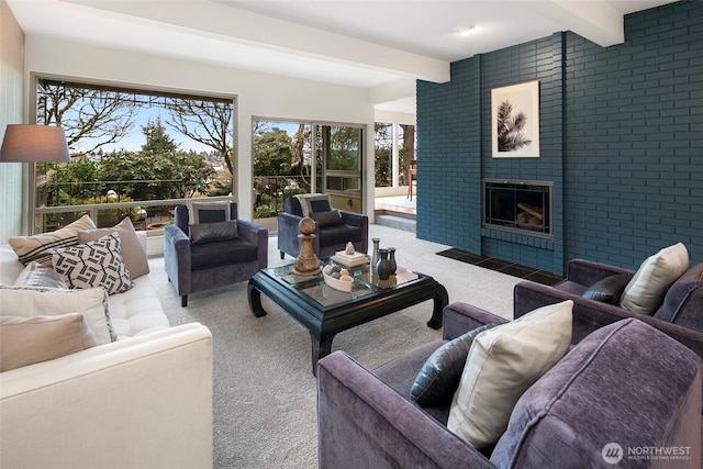 carpeted living area featuring beam ceiling and a fireplace