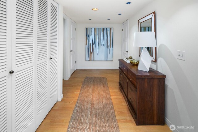 hallway featuring recessed lighting, baseboards, and light wood-style flooring