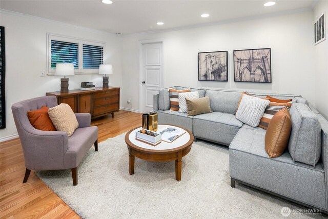 living area with light wood finished floors, recessed lighting, and ornamental molding