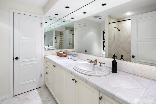 full bath with vanity, visible vents, recessed lighting, a tile shower, and tile patterned floors