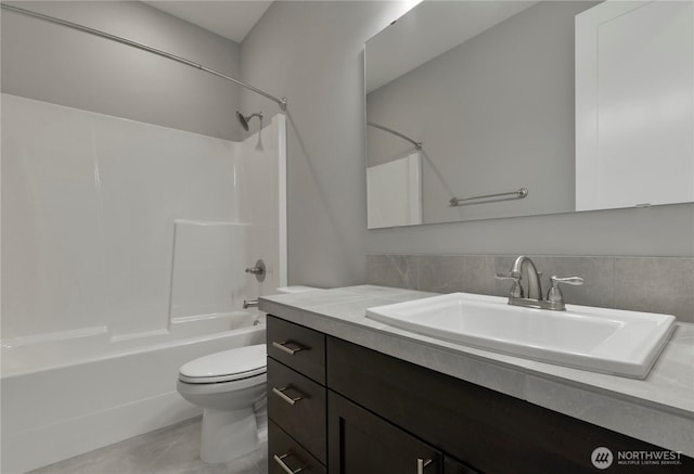 bathroom with tub / shower combination, toilet, and vanity