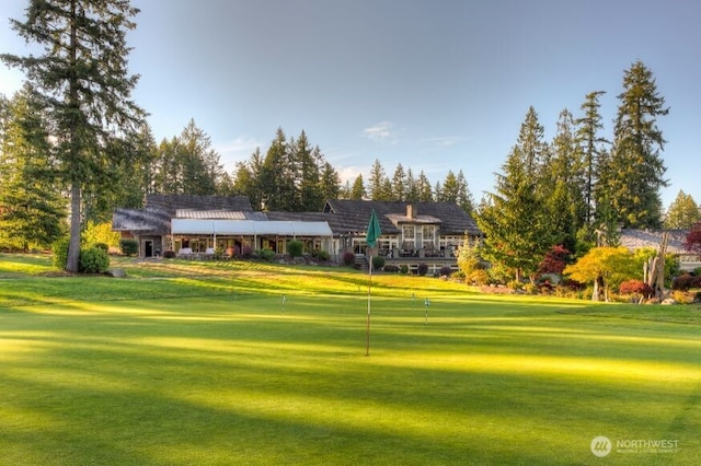 view of home's community with a lawn and golf course view