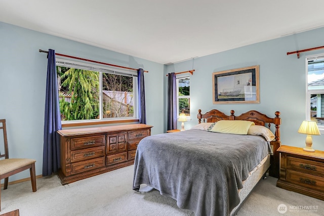 bedroom featuring light carpet