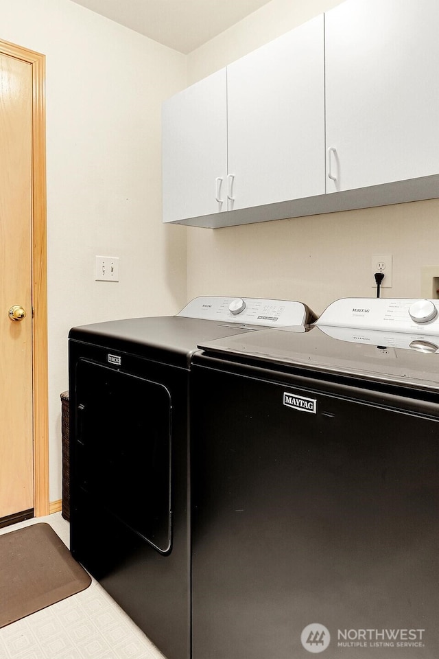 laundry area with tile patterned floors, cabinet space, and separate washer and dryer