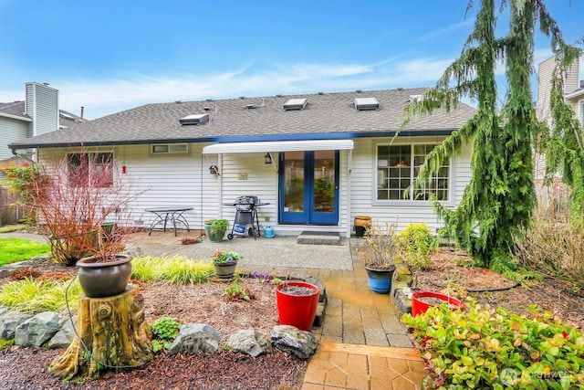 back of house featuring a patio area, french doors, and a shingled roof