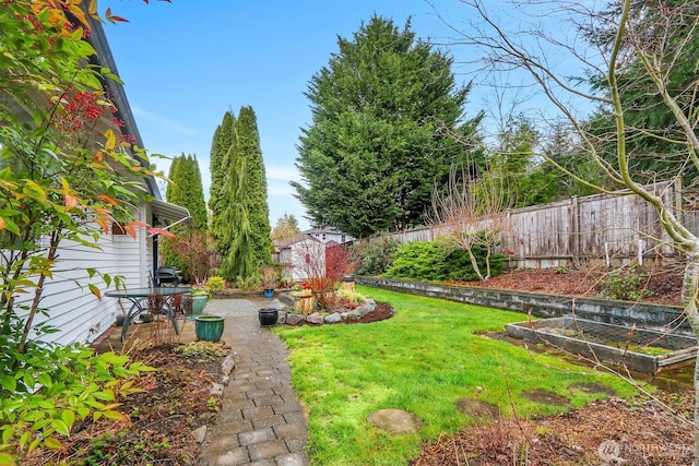 view of yard with a garden and fence