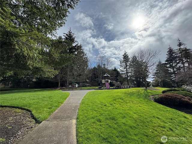 surrounding community with a lawn and playground community