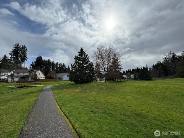 exterior space with a lawn and fence