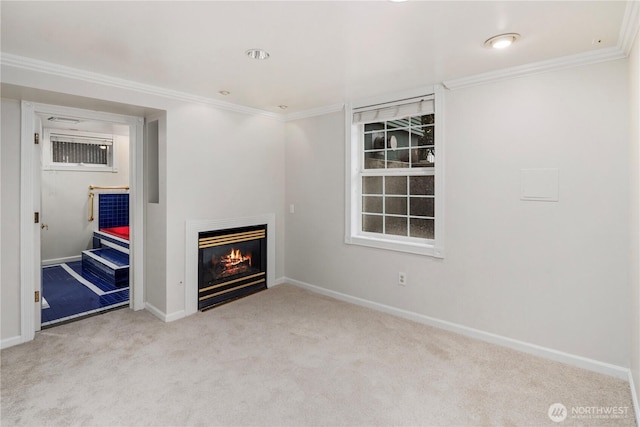 unfurnished living room with a glass covered fireplace, baseboards, carpet floors, and ornamental molding