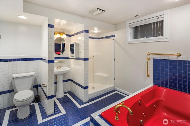 full bathroom featuring visible vents, toilet, tile walls, and tile patterned flooring