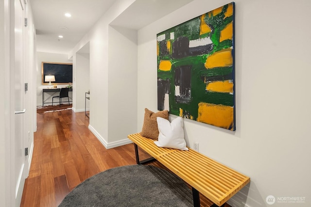 hall featuring recessed lighting, baseboards, and wood finished floors
