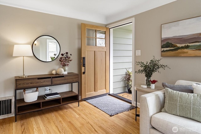 entryway with wood finished floors and visible vents