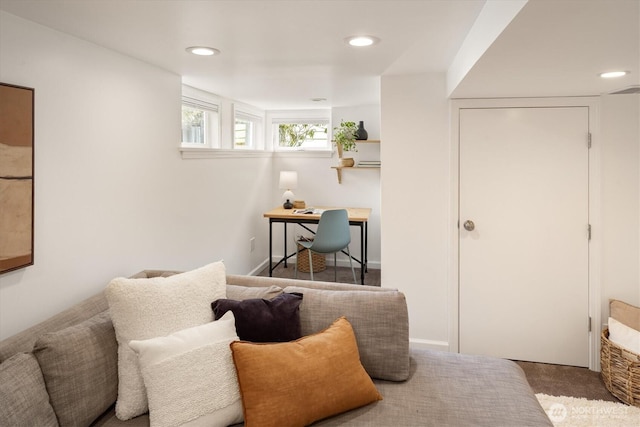 living area featuring recessed lighting and carpet