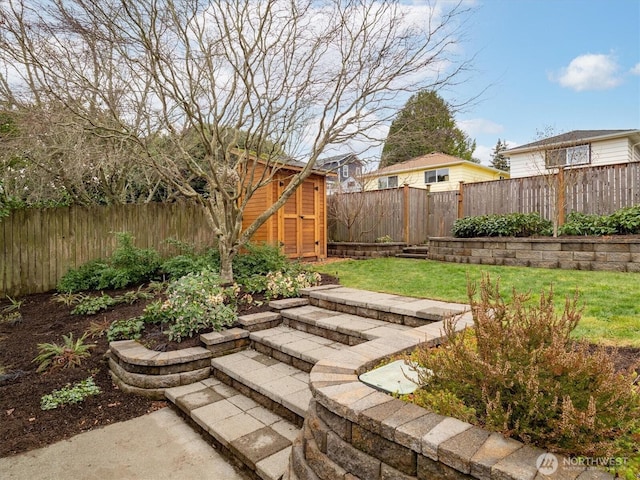 view of yard featuring an outbuilding, a storage unit, and a fenced backyard