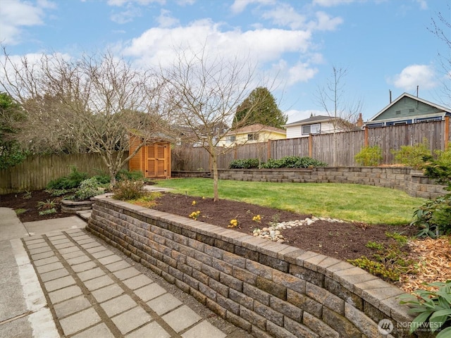 view of patio / terrace featuring a storage unit, an outdoor structure, and a fenced backyard