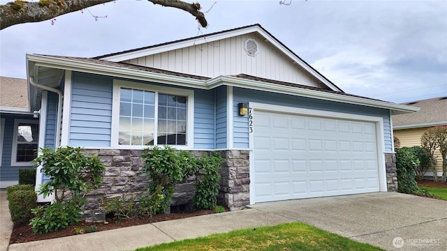 ranch-style house with stone siding, an attached garage, and driveway