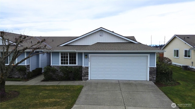 ranch-style home featuring central air condition unit, stone siding, driveway, and a shingled roof