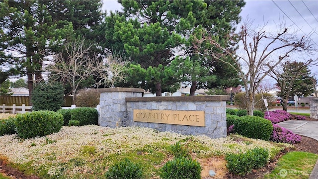 community sign featuring fence