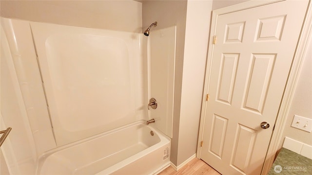 full bathroom with shower / bathing tub combination and baseboards