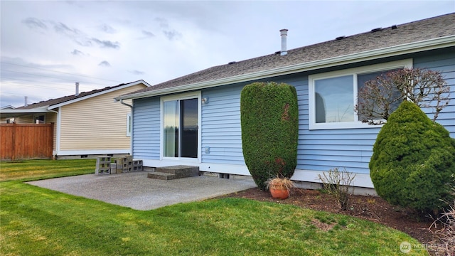 back of property featuring a yard, a patio area, and fence