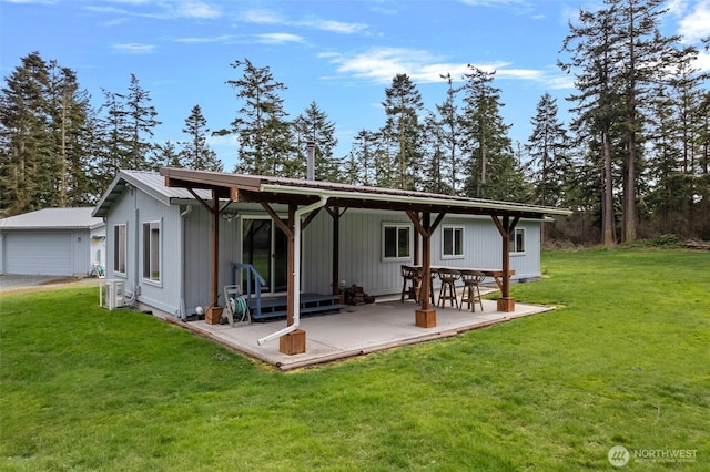 back of house featuring a yard and metal roof