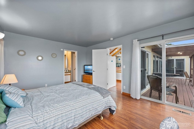 bedroom with visible vents, baseboards, wood finished floors, and access to outside