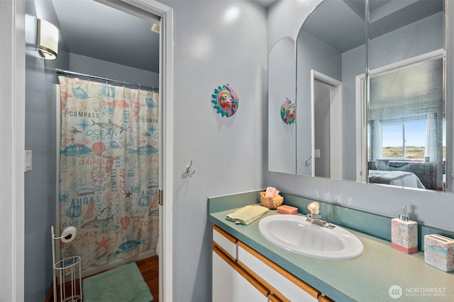 ensuite bathroom featuring ensuite bath, curtained shower, and vanity