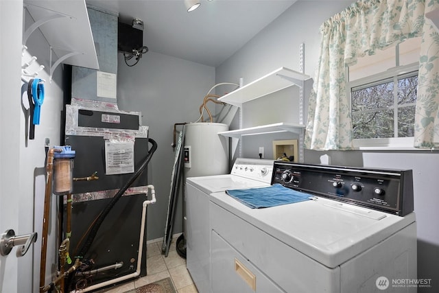 laundry room with light tile patterned floors, electric water heater, laundry area, and washing machine and clothes dryer