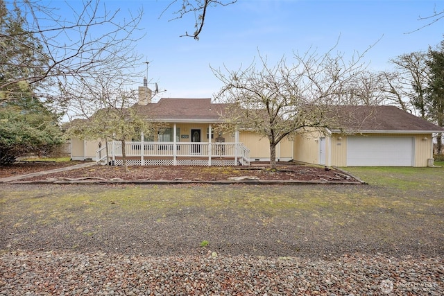 view of front of house featuring an attached garage, a shingled roof, a porch, a chimney, and driveway