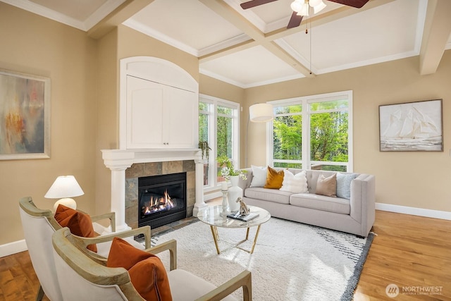 living area featuring ceiling fan, baseboards, wood finished floors, and coffered ceiling