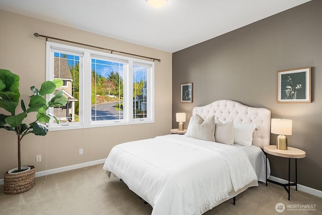 bedroom with baseboards and carpet