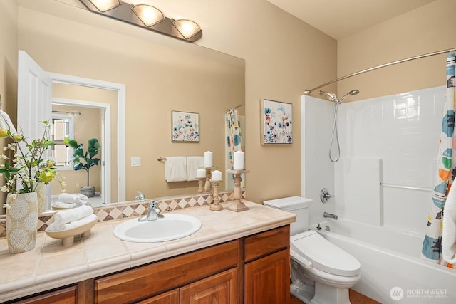 bathroom with shower / bath combo, vanity, and toilet