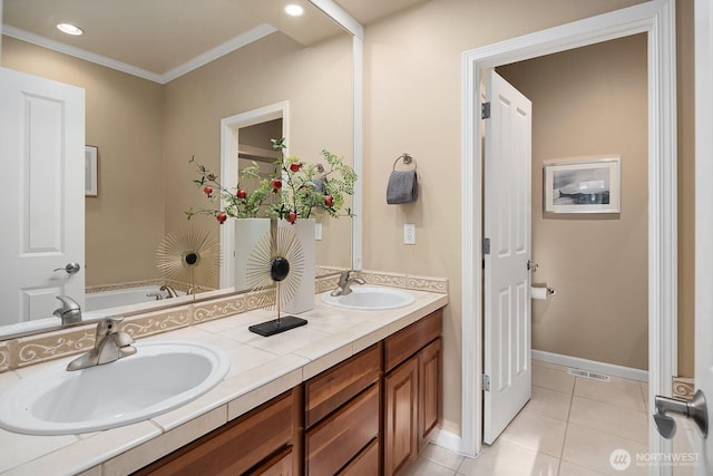 bathroom featuring tile patterned flooring, visible vents, a sink, and double vanity