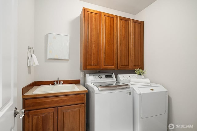 laundry room with washer and dryer, a sink, and cabinet space