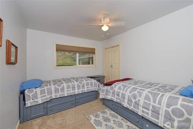 carpeted bedroom featuring a closet and a ceiling fan