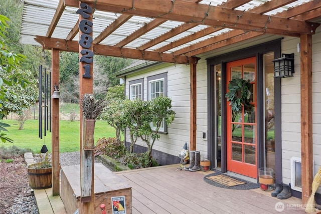 wooden deck featuring a lawn and a pergola