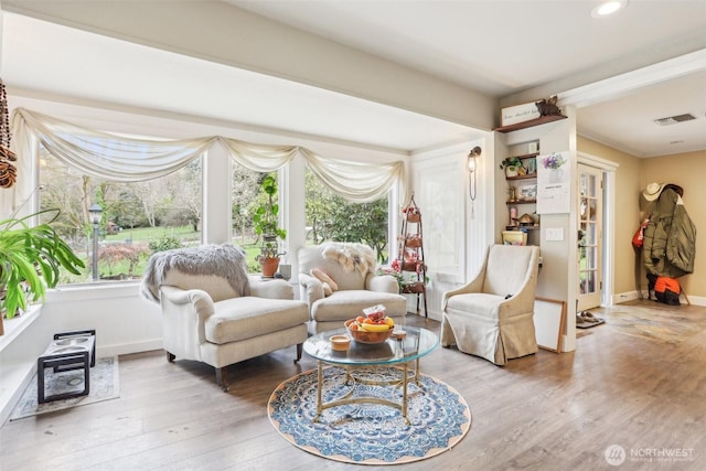 living room with recessed lighting, wood finished floors, visible vents, and baseboards