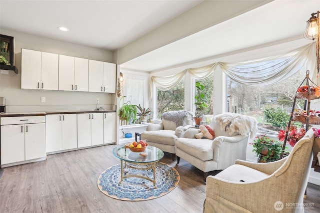 living area with recessed lighting and light wood-type flooring