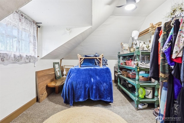 carpeted bedroom featuring vaulted ceiling